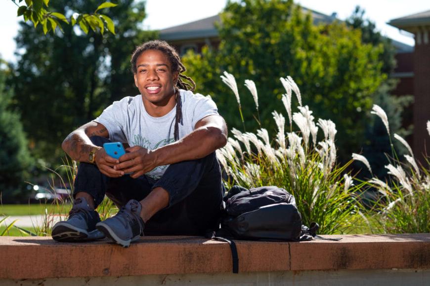 college student holding phone